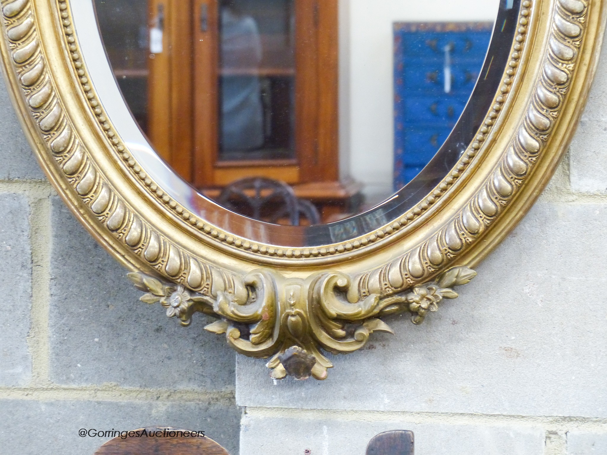 A late Victorian, gilt wood and gesso oval wall mirror, with bird pediment, W-63, H-96cm.